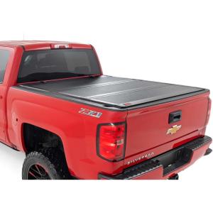 imageRough Country Hard TriFold FlipUp Truck Bed Tonneau Cover for Chevy Silverado ampamp GMC 15002500HD3500HD 20142019  Fits 67quot 788789quot Bed with Rail Caps